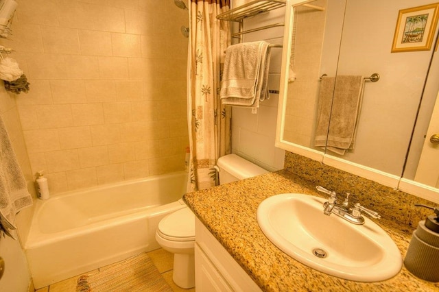 full bathroom with vanity, shower / bath combo with shower curtain, toilet, and tile patterned flooring