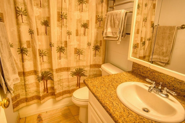 full bathroom with tile patterned flooring, shower / bath combo, vanity, and toilet