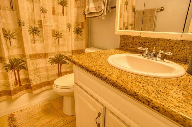 full bathroom with vanity, toilet, shower / bathtub combination with curtain, and tile patterned floors