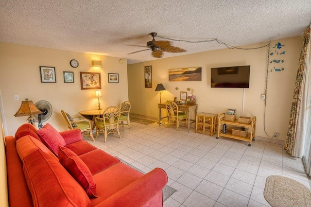 tiled living room featuring ceiling fan and a textured ceiling