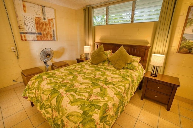 tiled bedroom featuring a textured ceiling