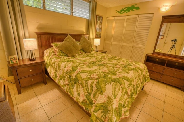 tiled bedroom with a closet