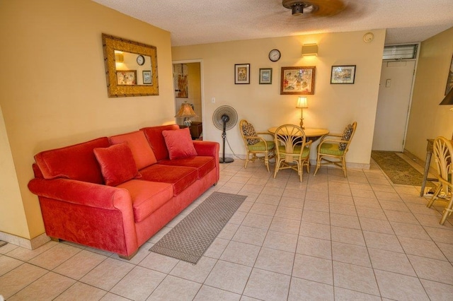 living room with a textured ceiling and light tile patterned floors