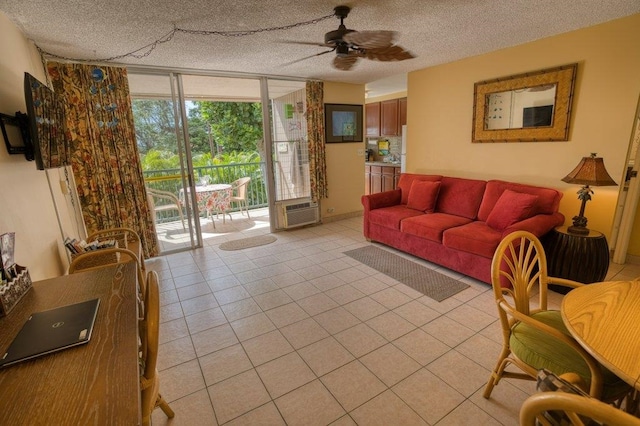 living room featuring ceiling fan, light tile patterned flooring, and a textured ceiling