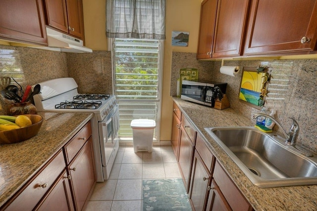 kitchen with light tile patterned flooring, sink, ventilation hood, white range with gas cooktop, and decorative backsplash