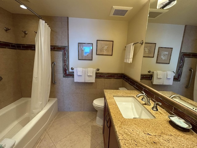 full bathroom featuring tile patterned flooring, tile walls, shower / bathtub combination with curtain, toilet, and visible vents