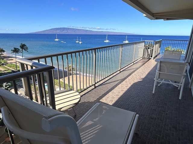 balcony featuring a water and mountain view