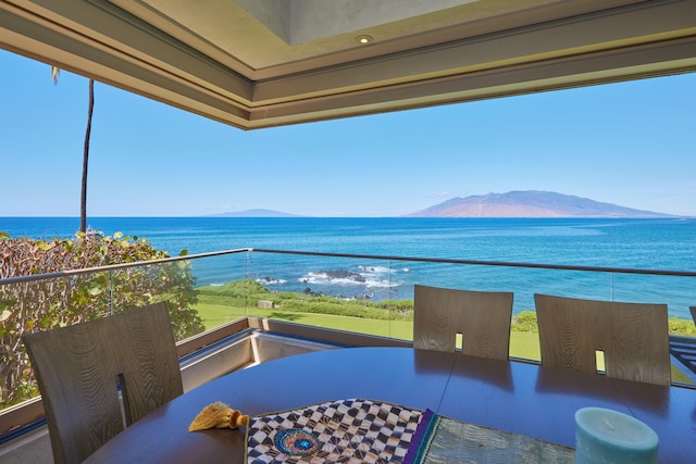 balcony featuring a water and mountain view