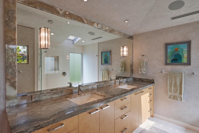 bathroom with vanity, a skylight, and walk in shower