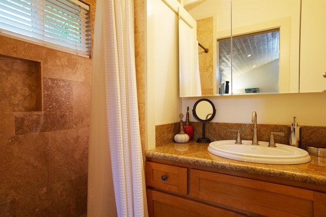 bathroom with vanity, lofted ceiling, and walk in shower
