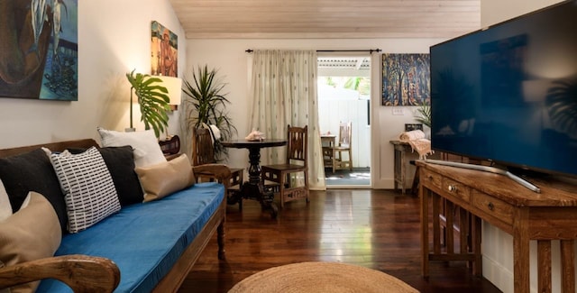 living area featuring dark wood-type flooring, lofted ceiling, and wood ceiling