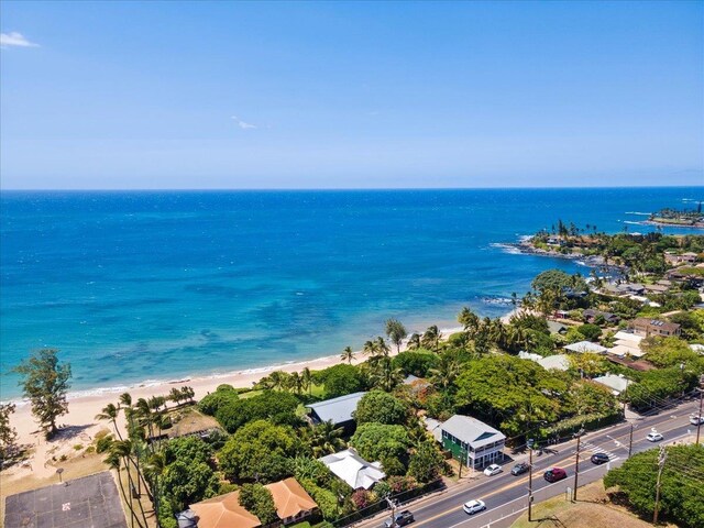 aerial view with a water view and a beach view