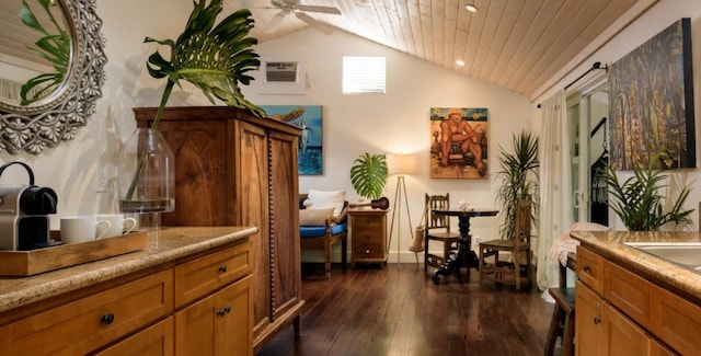 living room with a wall mounted air conditioner, dark hardwood / wood-style flooring, and vaulted ceiling