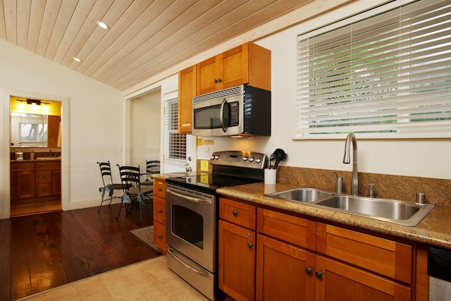 kitchen with wooden ceiling, appliances with stainless steel finishes, lofted ceiling, and sink