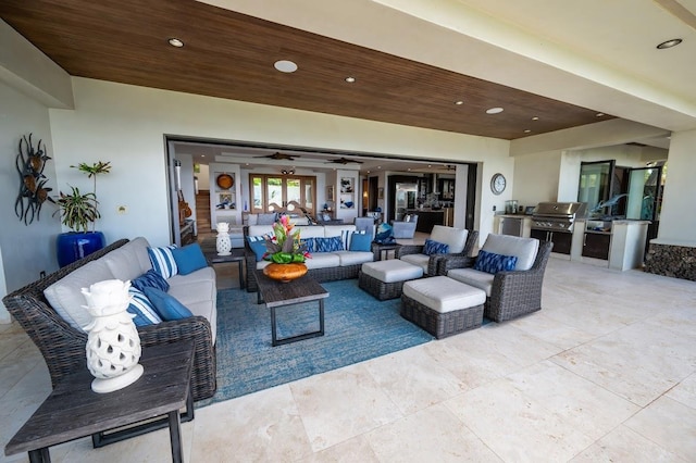 view of patio with exterior kitchen, outdoor lounge area, and grilling area