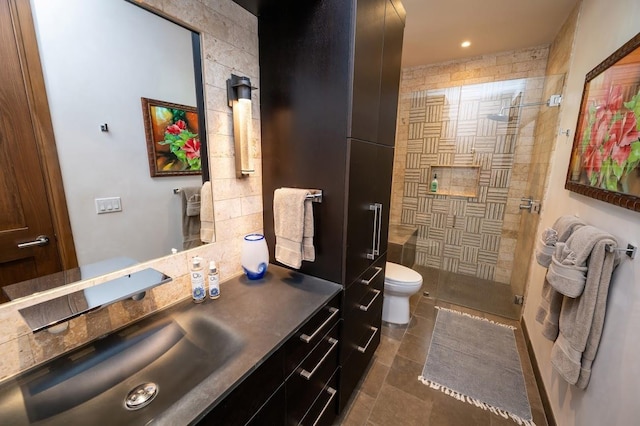 bathroom featuring toilet, walk in shower, and vanity