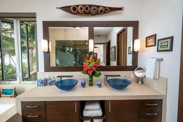 bathroom with a shower with shower door and vanity