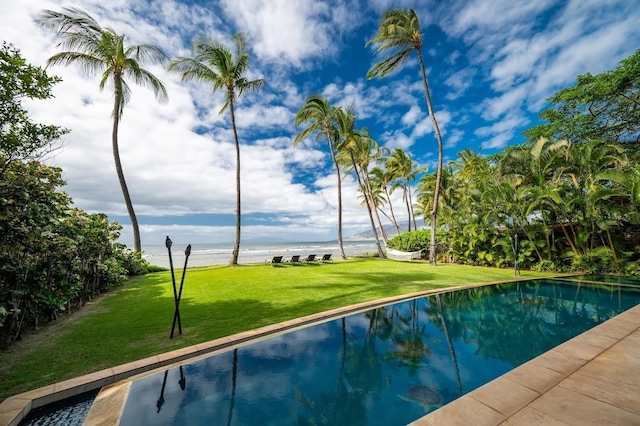 view of swimming pool featuring a water view and a yard