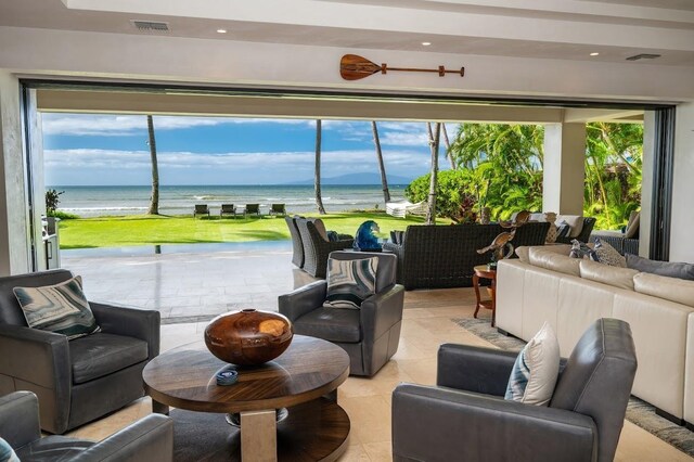 tiled living room with a water view