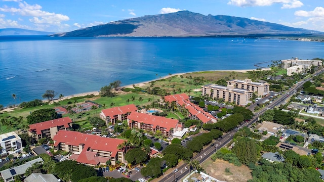 drone / aerial view featuring a water and mountain view