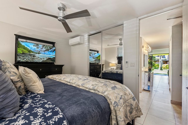 bedroom featuring ceiling fan, light tile patterned floors, a closet, and a wall mounted AC