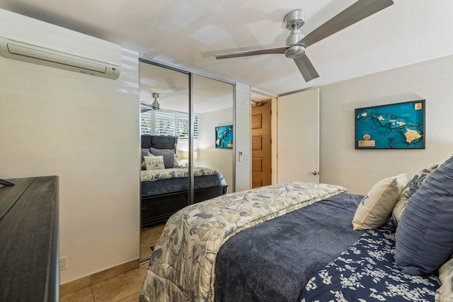 tiled bedroom featuring a wall mounted AC, a closet, and ceiling fan