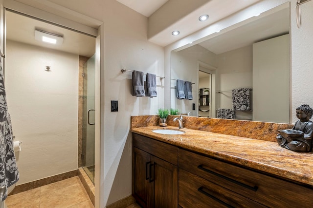 bathroom featuring an enclosed shower, vanity, and tile patterned floors