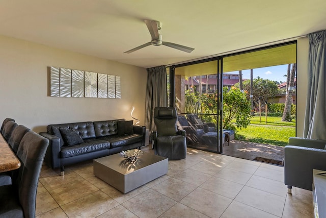 tiled living room featuring expansive windows and ceiling fan