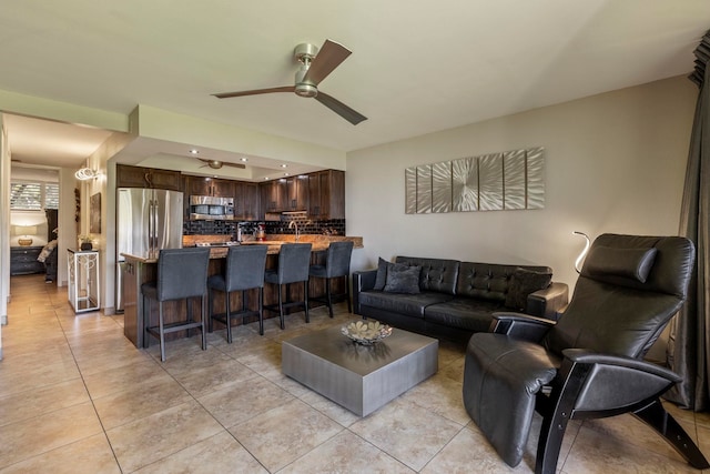 tiled living room with ceiling fan