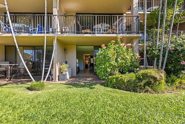 exterior space with a patio area and a lawn