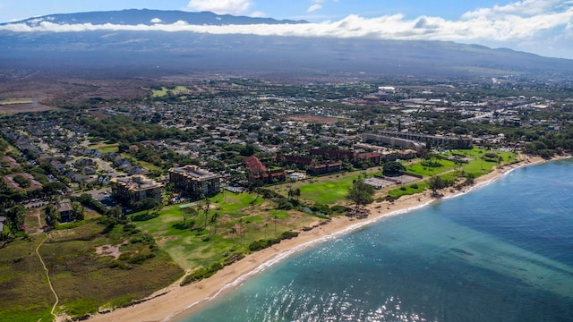 birds eye view of property featuring a beach view and a water and mountain view