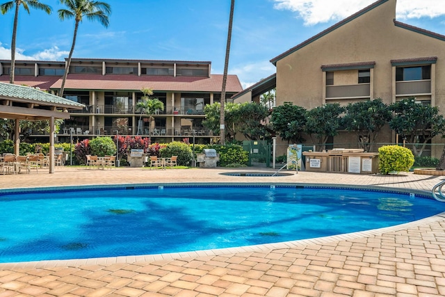 view of swimming pool featuring a hot tub