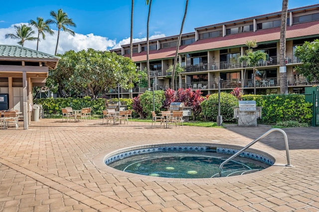 view of pool with a patio, area for grilling, and a community hot tub