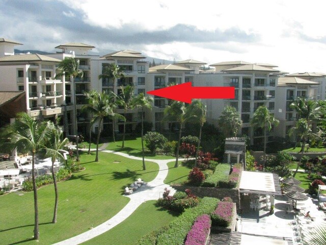 view of property's community with a lawn