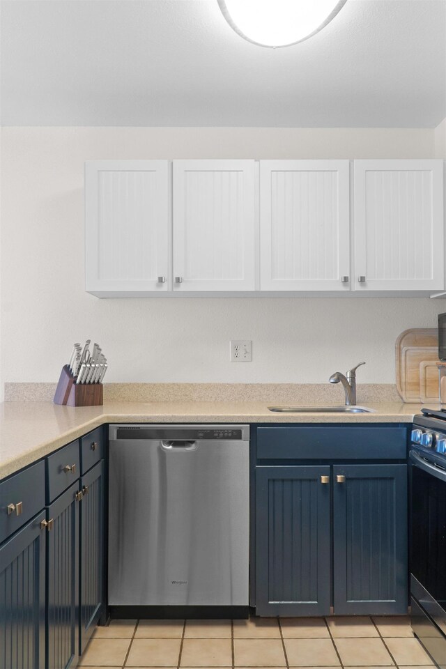 kitchen with dishwasher, black range oven, sink, light tile patterned floors, and white cabinetry