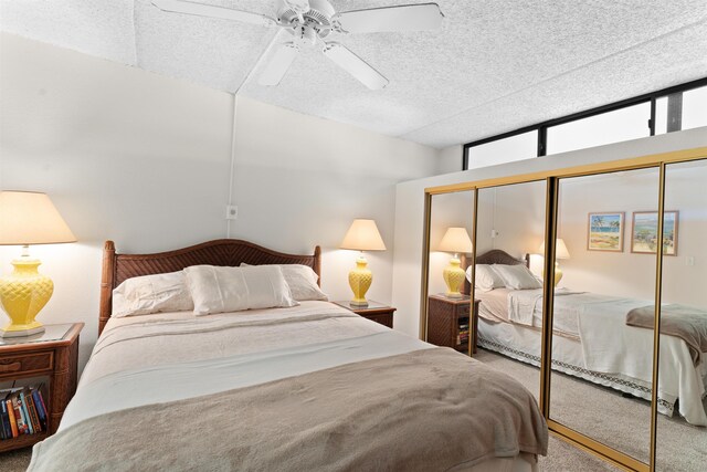 carpeted bedroom featuring ceiling fan and a closet