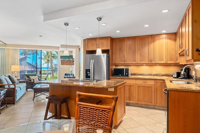 kitchen featuring light tile patterned flooring, stainless steel fridge with ice dispenser, stone countertops, a sink, and decorative backsplash