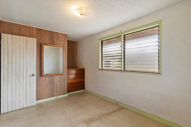 unfurnished room with a textured ceiling