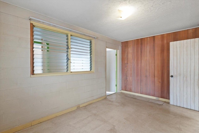 unfurnished room featuring radiator and a textured ceiling