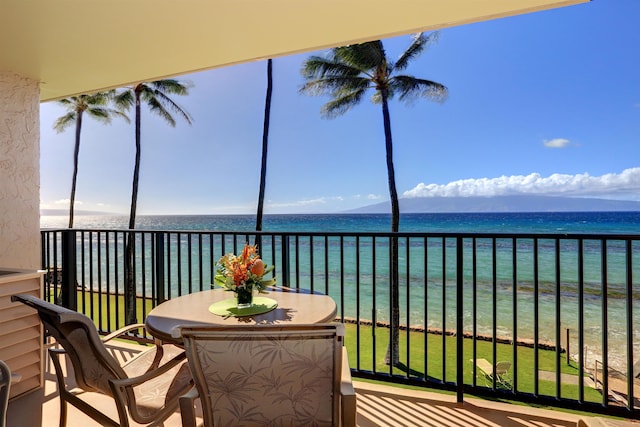 balcony featuring a water view and a view of the beach