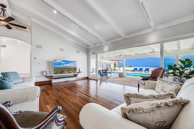 living room with dark hardwood / wood-style floors, lofted ceiling with beams, ceiling fan, and track lighting