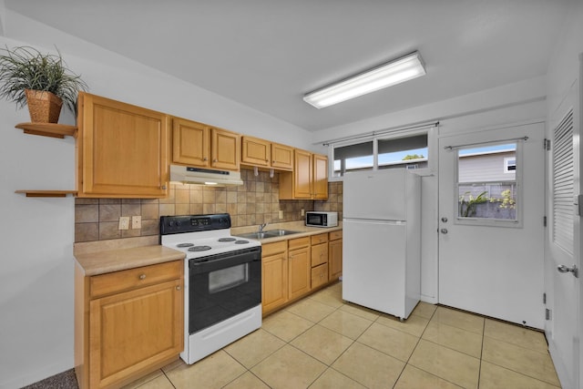 471 Liholiho St Unit 23, Wailuku, HI 96793 - kitchen with open shelves, white appliances, under cabinet range hood, decorative backsplash, and light countertops