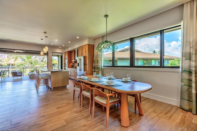 dining area with light wood-type flooring and plenty of natural light