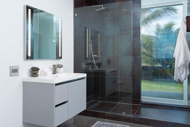 bathroom featuring vanity and tiled shower