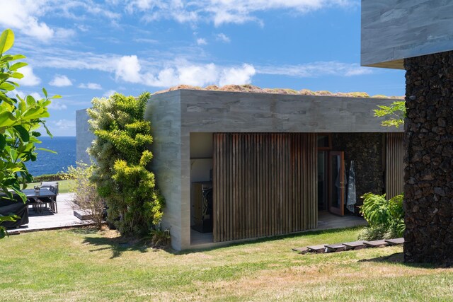 view of outdoor structure with a yard and a water view