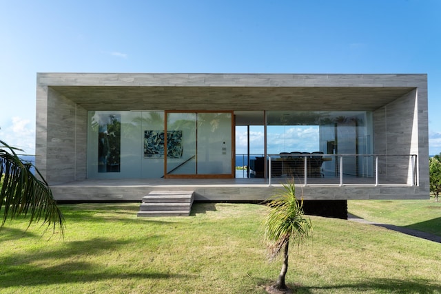 rear view of house with a lawn