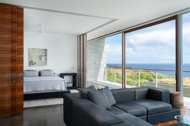 bedroom with a water view, ceiling fan, and floor to ceiling windows