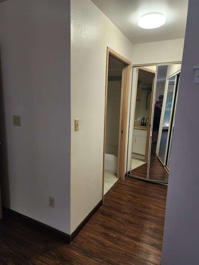 hallway featuring dark hardwood / wood-style flooring