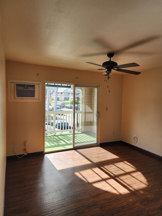 spare room with a textured ceiling, dark hardwood / wood-style floors, ceiling fan, and a wall mounted air conditioner