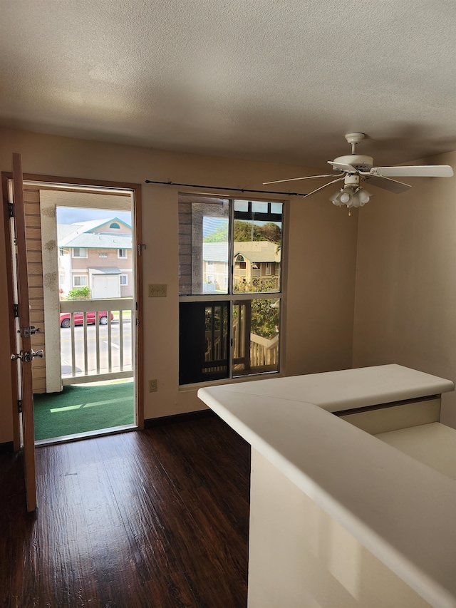 entrance foyer with ceiling fan, dark hardwood / wood-style floors, and a textured ceiling